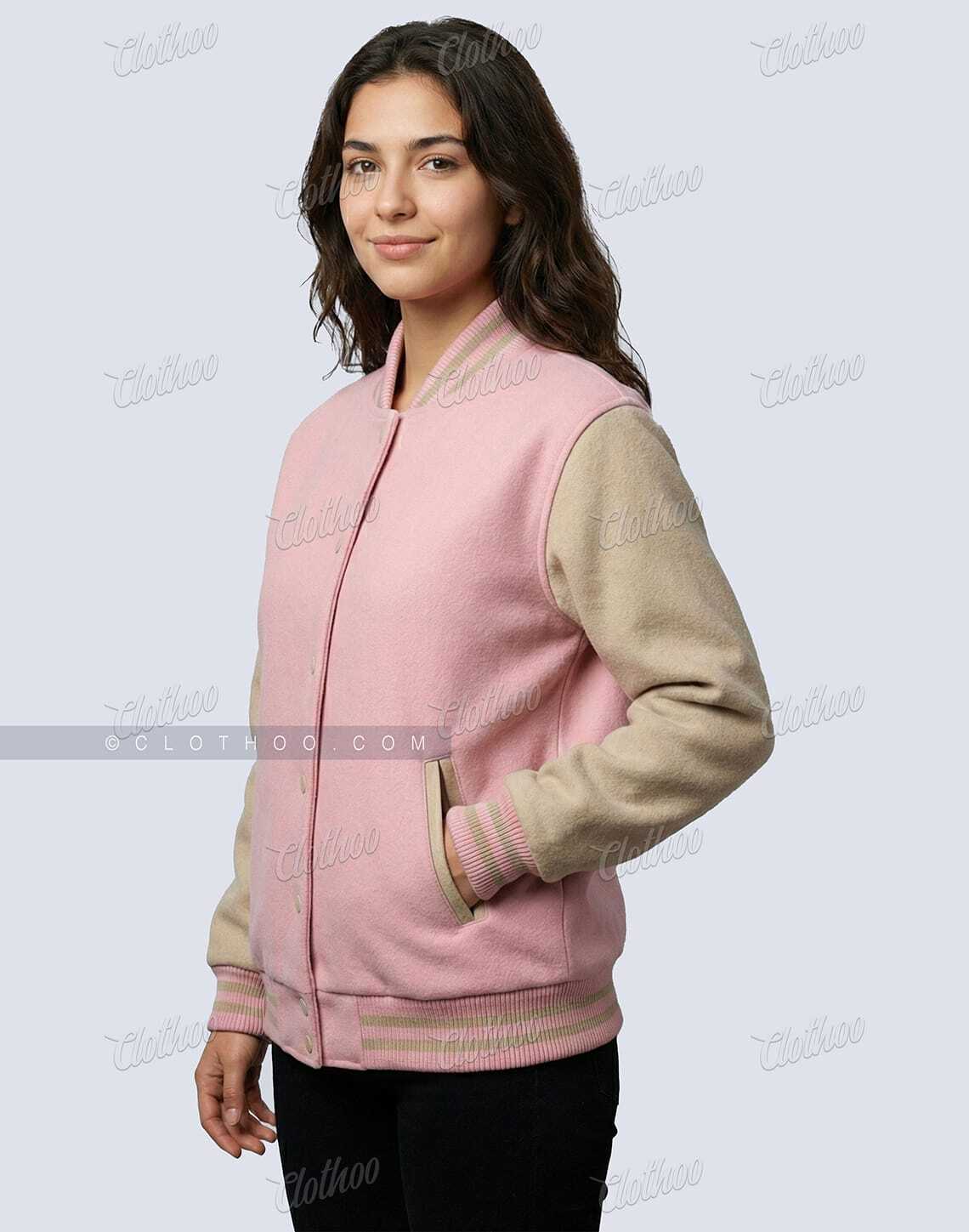 Side view of women’s baby pink and beige wool varsity jacket with striped rib knit cuffs